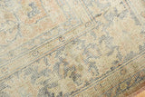 Distressed Oushak rug texture revealing even wear, visible knot heads, ivory, and blue.
