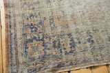 Vintage distressed Oushak rug corner with visible knot heads and blue, blush patterns.