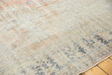 Textured distressed Oushak rug with faded rose blush and blue patterns, showing visible knot heads.