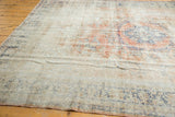 Distressed vintage Oushak rug with worn pile showing knot heads, rose and ivory tones.