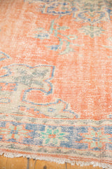 Distressed vintage Oushak rug pile, pale red and sky blue Rococo motifs, foundation showing, fringe.