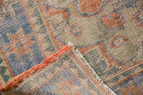 Distressed Oushak carpet detail, showing worn pile, secured side, and pale ivory fringe.
