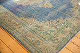 Distressed vintage Oushak carpet corner, showing worn abrash sky blue and patterned antique ivory border with mint accents.