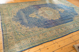 Distressed sky blue field and patterned beige, mint border on a vintage Oushak rug corner.