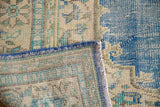Distressed blue and beige pile texture of 1950s vintage Oushak rug with even wear.