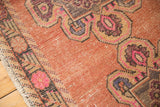 Distressed Turkish Oushak runner: abrashed blush field, worn pile, pink and charcoal accents.