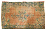 Distressed Oushak carpet, blush abrashed field, faded blue scalloped medallion with aqua.