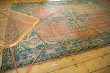 Distressed Oushak rug showing blush abrashed field, faded blue and aqua patterns, even wear.