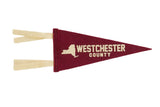 Westchester County crimson felt pennant with a cream New York State graphic and lettering.