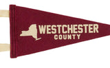 Cream-colored New York State graphic and lettering on the crimson wool felt pennant.