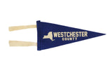 Royal blue Westchester County felt pennant with New York State graphic, 4 by 9 inches.