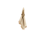 Natural colored linen cocktail napkin, folded, with playful fringe and aqua blanket stitch.