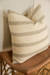 Pillow corner with textured off-white and speckled beige remnant wool stripes.