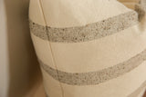Textured cream wool pillow fabric with delicate beige flecked stripe detail.