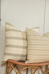 Two remnant wool fabric pillows featuring distinct delicate striping and textures.