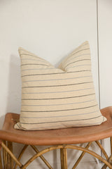 Lower portion of the striped silk fabric pillow, showing texture and delicate stripes.