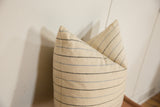 Remnant silk pillow with fine woven texture and delicate black and light blue stripes.