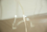 Thick clear Lucite material showing a smooth curve and bright reflections.