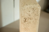 Beveled corner of the vintage lamp showing its porous faux travertine texture.