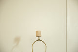 Detail view of the vintage lamp's textured faux travertine socket and brass harp.
