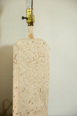 Brass socket and hardware on top of the textured faux travertine lamp.