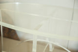 Thick clear Lucite oval top with intersecting crisscross base of the vintage coffee table.