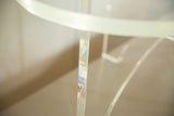 Thick oval Lucite top edge and clear base detail of the vintage coffee table.