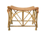 Vintage deerskin foot stool with curved tan leather seat, X-frame bamboo, and metallic bell feet.