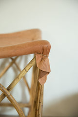 Deerskin upholstery detail, secured with natural twine to the golden rattan foot stool frame.