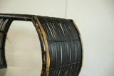 Chippy black paint and woven rattan texture on vintage bamboo foot stool.