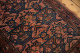 Low pile of the vintage Bibikabad rug showing raspberry and navy geometric floral motifs.