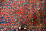 Antique Fereghan carpet's madder root red field, scrolling arabesques, intricate florals, mostly even wear.