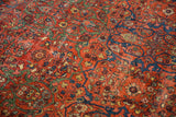 Madder root red Fereghan carpet, intricate scrolling arabesques, pistachio, cobalt florals with wear.