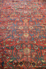 Intricate floral arabesques in madder red, cobalt, pistachio on antique Fereghan, showing wear.