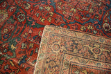 Close-up of Antique Fereghan carpet's worn madder red pile and intricate hand-knotted foundation.