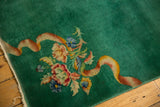 Emerald green Art Deco rug corner detail with intricate floral bouquet and expressive ribbon.