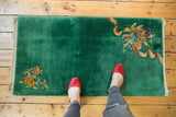 Emerald green vintage Chinese Art Deco runner rug with asymmetric floral bouquets and ribbon detail.