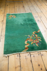 Emerald green field of the vintage Chinese Art Deco runner with ornate floral ribbon bouquet.