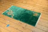 Emerald green vintage Art Deco runner rug with ribboned asymmetric floral arrangements.