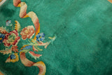 Intricate floral bouquet with expressive ribbon detail on emerald green Art Deco rug pile.