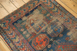 Antique Caucasian rug corner, geometric design with coral borders, worn field showing foundation.