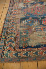 Detailed geometric border and exposed foundation of a hard-worn antique Caucasian rug.