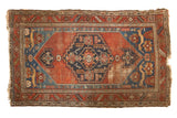Antique Malayer rug, geometric medallion on madder red field, sapphire blue spandrels, feline motifs.