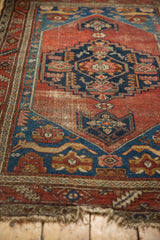 Antique Malayer rug lower corner, sapphire blue spandrel with feline figures, and aged madder field.
