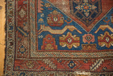 Antique Malayer rug corner, sapphire blue field, madder red borders, cat motif, tattered fringe.