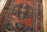 Antique Malayer rug detail: sapphire blue corner with cat-like creatures and madder red abrashes.