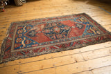 Antique Malayer rug corner: sapphire blue spandrel with elongated cat-like creatures and fringe tatter.