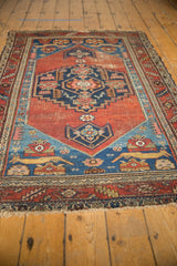 Antique Persian Malayer rug, madder red field, navy blue medallion, sapphire spandrels with feline motifs.