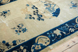 Peking rug antique ivory field, blue bird, floral motifs, visible wear, dark blue border.