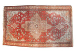 Antique Farahan Sarouk rug with central medallion, delicate floral field, terra cotta, ivory, aged silver patina.